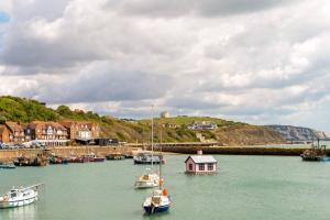 a group of boats in the water in a harbor at The Grand Burstin Hotel in Folkestone +25 photos