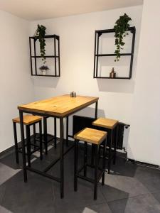 a table and two stools in a room at Suite Julius Cesar in Berlin +14 photos