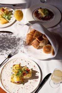 a table with plates of food and glasses of wine at Bor Hotel by Karisma in Zlatibor