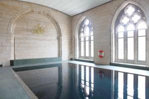 an empty swimming pool in a building with windows at Cottage 7 - Skye Cottage in Fort Augustus