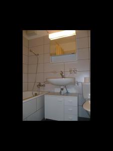 a bathroom with a sink and a toilet at LAAX Homes - Maighels 8-9 in Laax-Murschetg