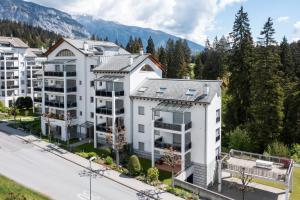 an aerial view of a large white apartment building at LAAX Homes - Val Mulin 14,2 in Laax-Murschetg