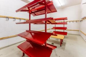 a group of red benches in a room at LAAX Homes - Val Mulin 14,2 in Laax-Murschetg