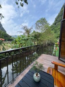 a balcony with a view of a river and mountains at Trang an mountain view bungalow in Nguyên Ngoại
