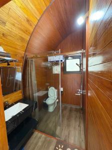 a bathroom with a toilet and a sink and a shower at Trang an mountain view bungalow in Nguyên Ngoại