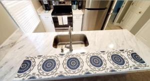 a kitchen with a sink with a blue and white at Coastal Getaway & Golf Retreat Condo in Pawleys Island