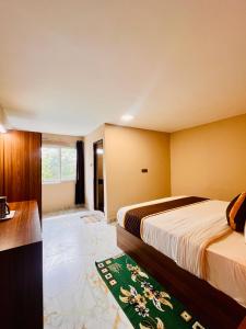a hotel room with two beds and a bathroom at Costa Green Garden- Luxury 4 bedroom bungalow Mountain view in Kodaikānāl