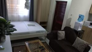 a small room with a bed and a couch at Mtwapa june apartment 3 in Mtwapa