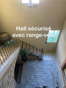 a staircase in a building with the words hall serviceagency axe range veto at Les Pichies, Studio Dadoum, Centre ville in Digoin