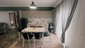 a kitchen with a table and chairs in a room at Bilalshome in Alexandroupoli