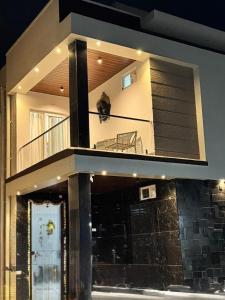 a cat sitting on the balcony of a house at Hangout Ville in Hyderabad