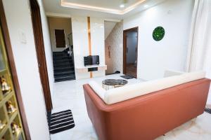 a living room with a couch and a television at Hangout Ville in Hyderabad +16 photos