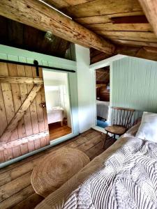 a bedroom with a large bed and a mirror at Nordhaven Retreat- Lofoten in Vestvågøya