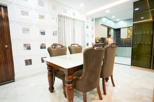 a dining room with a wooden table and chairs at Hangout Ville in Hyderabad