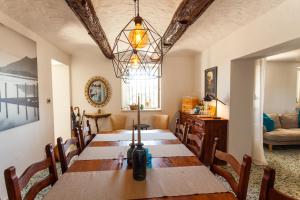 a dining room with a long table and chairs at La Dolcevita in Mombercelli +13 photos