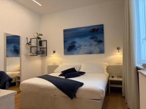 a bedroom with a bed in a room at Soleblu Guesthouse in Albissola Marina +12 photos