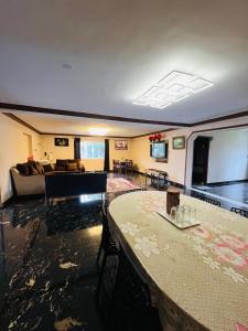 a living room with a table and a couch at Costa Green Garden- Luxury 4 bedroom bungalow Mountain view in Kodaikānāl