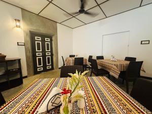 a dining room with tables and chairs and a ceiling at Sekkugala Villa in Koggala