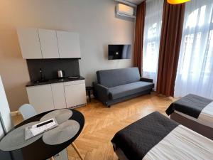a small living room with a table and a couch at Wroclaw City Apartments in Wrocław