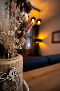 a vase filled with flowers in a living room at Résidence thermale La Chaldette in Brion