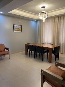 a dining room with a wooden table and chairs at The Villa Residences Katale in Kansiri