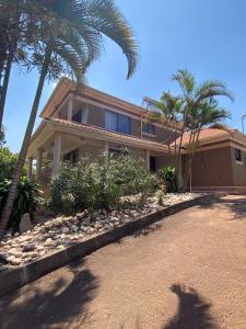 a house with palm trees in front of it at The Villa Residences Katale in Kansiri