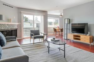 a living room with a couch and a tv at Blueground Edgewood Park pool nr Edgewood Park SFO-2060 in Redwood City