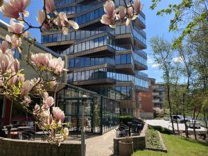 a building with pink flowers in front of it at Place Lund Apartments in Lund