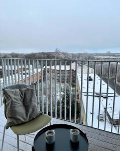 a balcony with a table and two cups of coffee at Place Lund Apartments in Lund