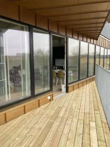 a large deck with glass windows on a building at Place Lund Apartments in Lund +22 photos