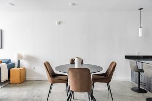 a table and chairs in a living room with a piano at Blueground New Tacoma balcony nr Museum SEA-954 in Tacoma +9 photos