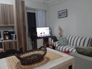 a living room with a couch and a television at Cozy Family Home - COP 30 in Belém
