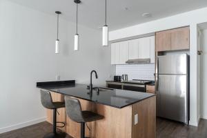 une cuisine avec un évier et un réfrigérateur dans l'établissement Blueground New Tacoma balcony nr Wright Park SEA-956, à Tacoma