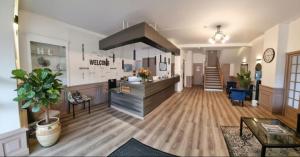 a large room with a kitchen and a living room at La Buissonnière in Corbigny