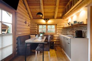 a kitchen with a table in a log cabin at Chalet am See in Bad Brambach