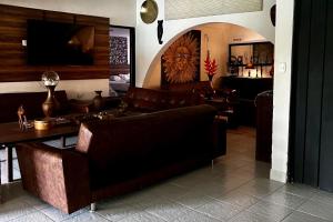 a living room with a couch and a table at Inviting 14-Bed Villa Sleeps 29 Parking in Toro