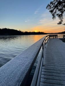 a dock on a body of water at sunset at Apartment in beautiful area Edsviken, close to Stockholm in Sollentuna
