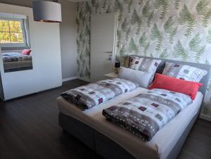 a couch with pillows on it in a room at FeWo Luzia in Losheim