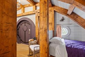 a bedroom with a purple bed and a door at Ancient Lore Village in Knoxville +176 photos
