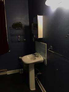 a bathroom with a sink and a black wall at Zen Hostel in Toronto +13 photos