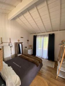 a bedroom with a large bed in a room at Bastide Blanche in Meigné-le-Vicomte