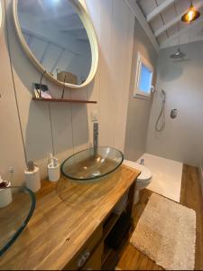 a bathroom with a glass sink and a mirror at Bastide Blanche in Meigné-le-Vicomte
