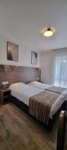 a large bedroom with two beds and a window at La Buissonnière in Corbigny