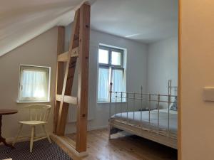 a bedroom with a bunk bed and a chair at Forsthaus Barsdorf in Fürstenberg