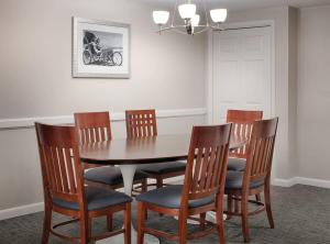 a dining room with a wooden table and chairs at Wyndham Ocean Walk Resort 2BR Apartment with Resort Access in Seabreeze