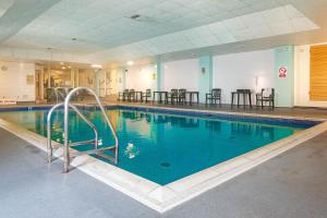 a large swimming pool in a building at The Grand Burstin Hotel in Folkestone