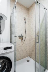 a shower in a bathroom with a glass shower stall at Status-M Apartments 187 in Becici
