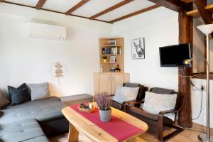 a living room with a couch and a table at Ferienhaus am Silbersee Frielendorf in Frielendorf