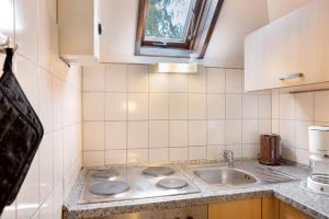 a kitchen with a sink and a counter top at Ferienhaus am Silbersee Frielendorf in Frielendorf +21 photos