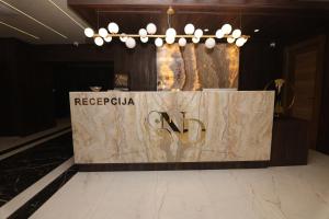 a podium in a lobby with a sign on it at Aqua Raj ND in Novi Pazar
